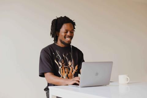 High school student using Macbook to receive online tutoring